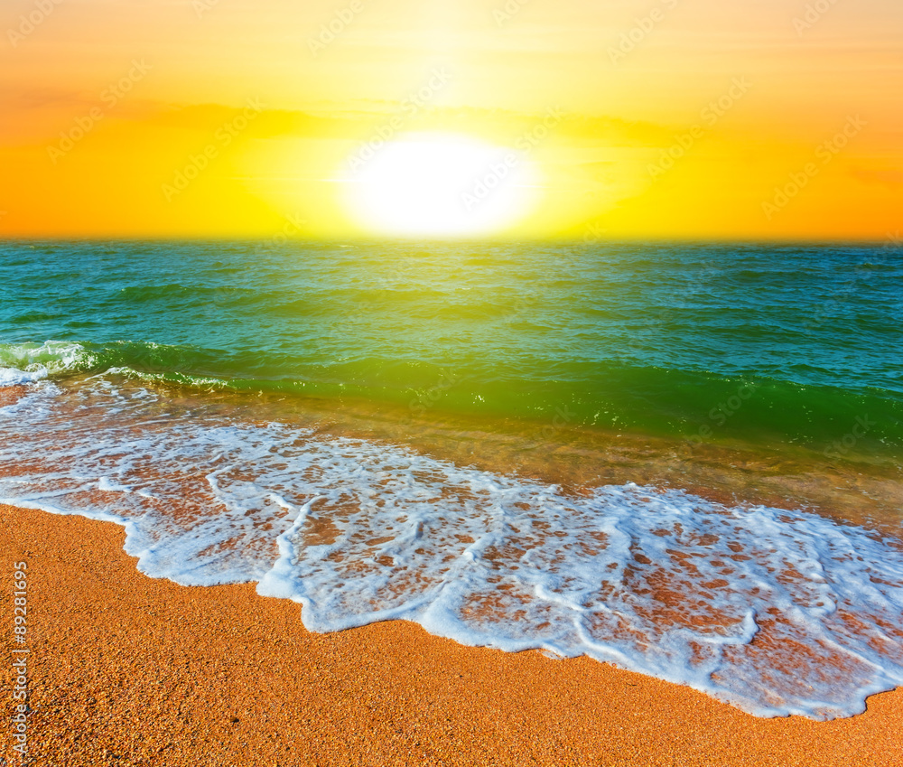 sunset over a sandy sea beach
