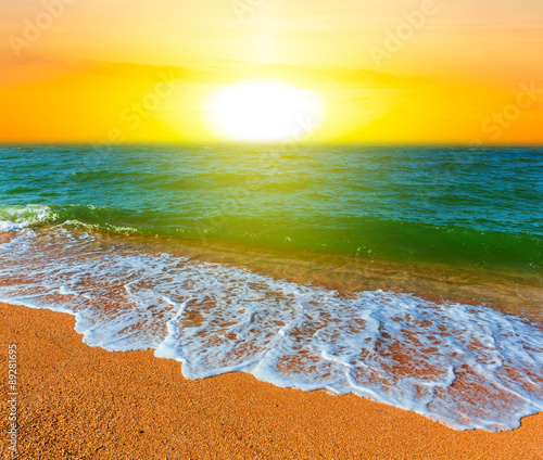 sunset over a sandy sea beach