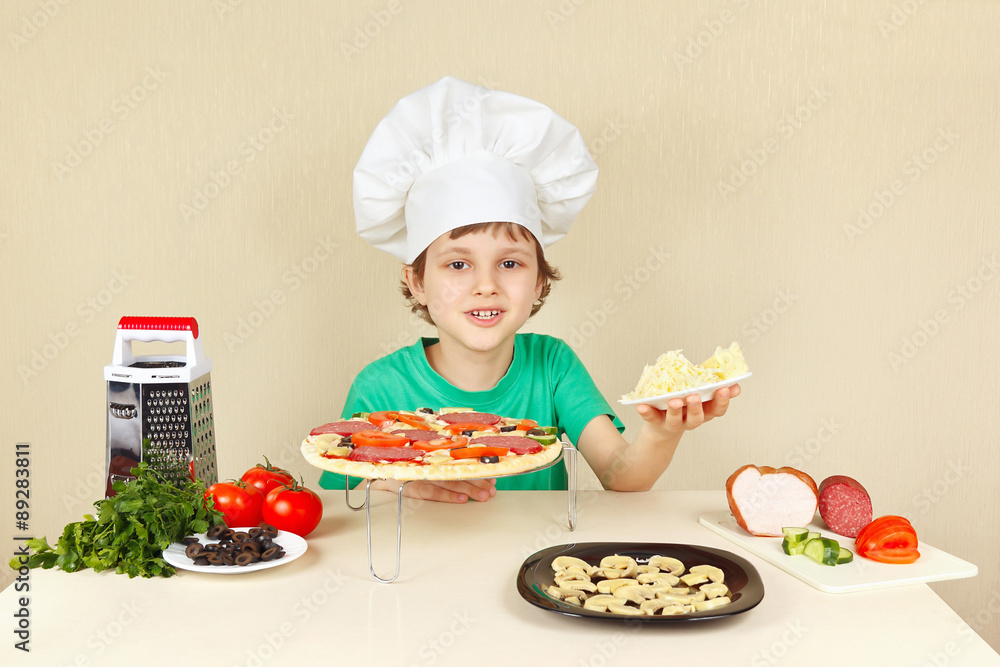 Little funny chef with a grated cheese for pizza Little funny chef with a grated cheese for pizza