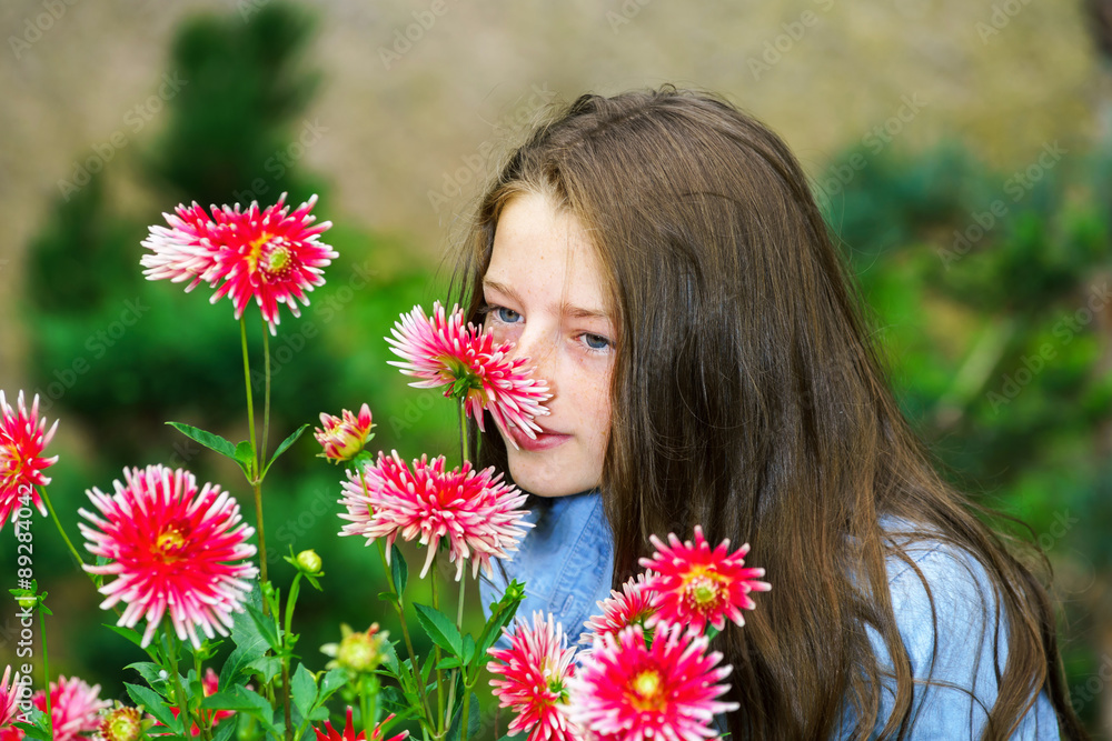 Naklejka premium Teenage schoolgirl portrait with natural flowers