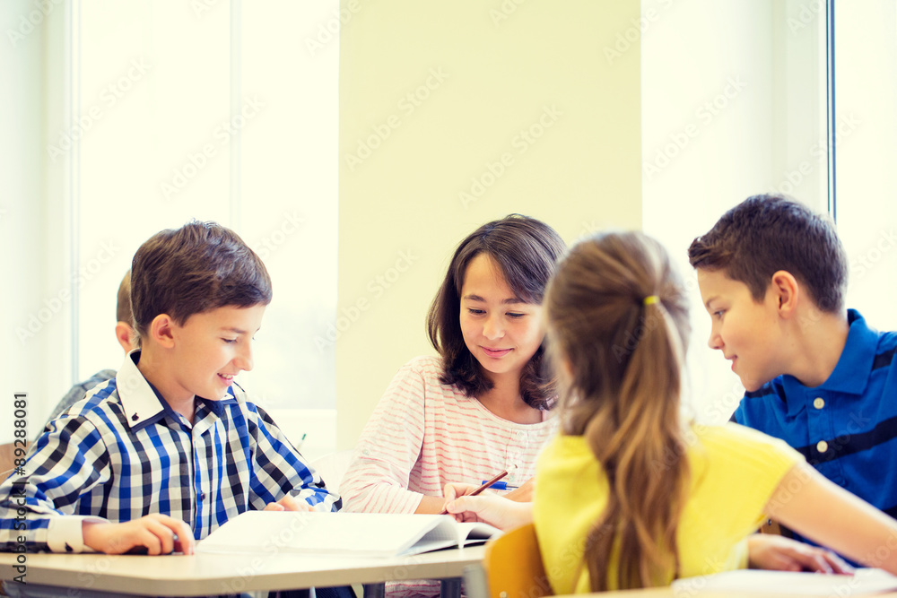 group of school kids writing test in classroom group of school kids writing test in classroom
