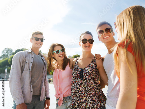 group of smiling friends in city © Syda Productions