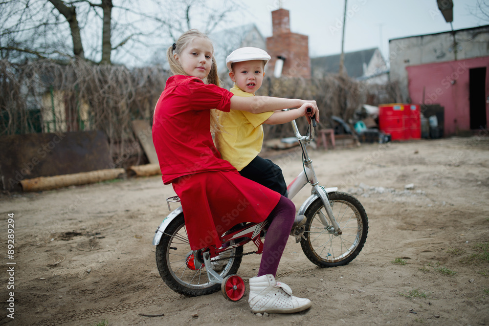 children ride on bicycle in yard children ride on bicycle in yard