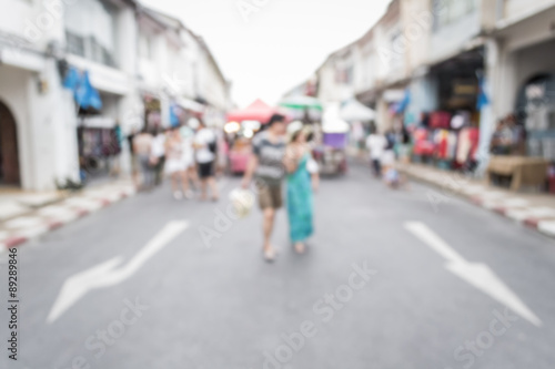 Blurred people walking on the street