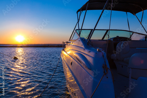Yacht near the pier against sunset