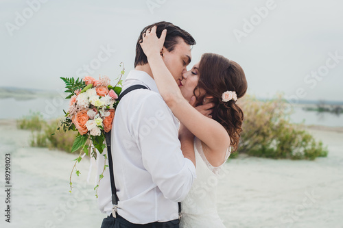 Kiss the bride and groom photo