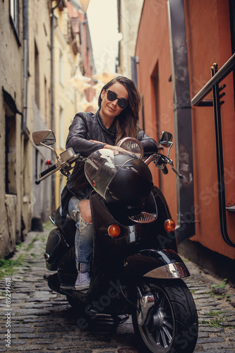 Casual girl on moto scooter. © Fxquadro
