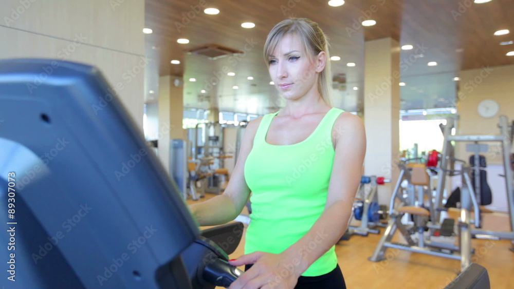 Young woman running on treadmill Young woman running on treadmill