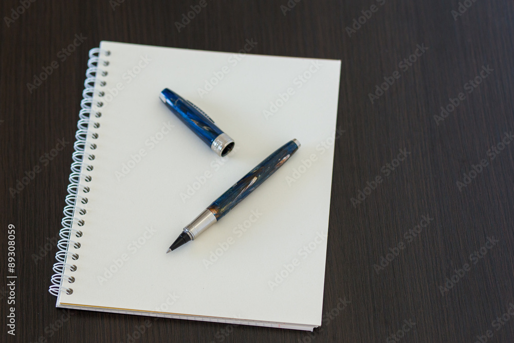 Blank notepad on office wooden table Blank notepad on office wooden table