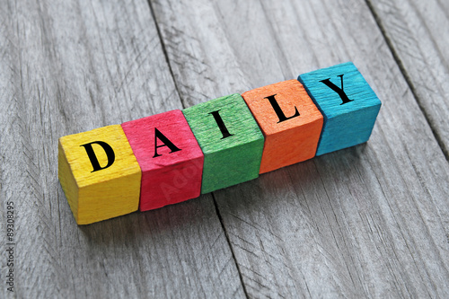 word daily on colorful wooden cubes