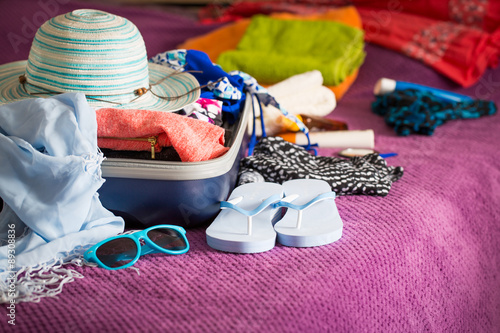 Photos Open suitcase on bed