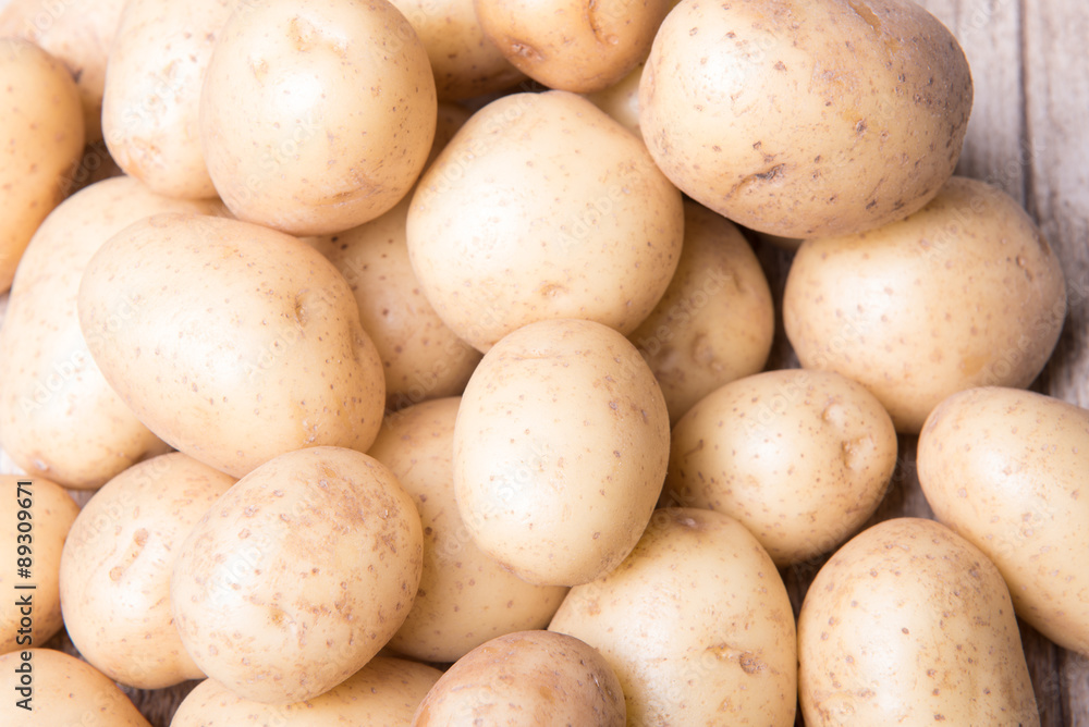 young potatoes on a wooden background young potatoes on a wooden background