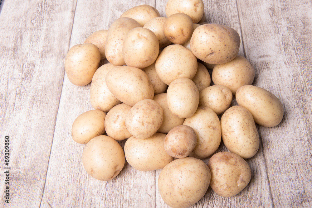 young potatoes on a wooden background young potatoes on a wooden background