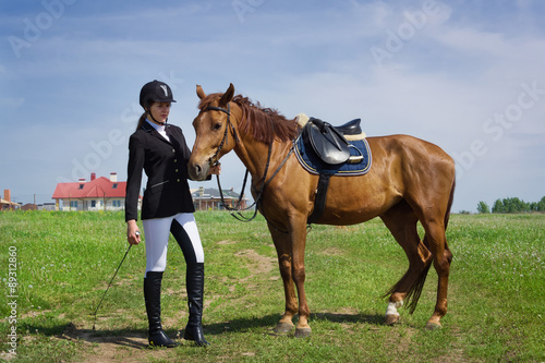 Beautiful young girl jockey with her horse © Demian