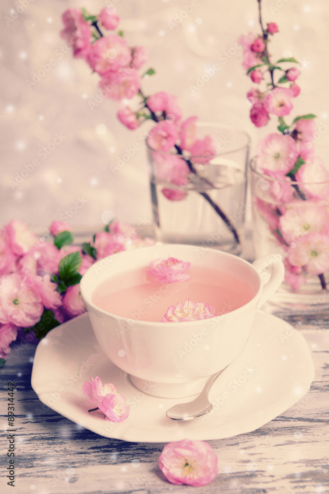 Cup of tea and beautiful fruit blossom on table Cup of tea and beautiful fruit blossom on table
