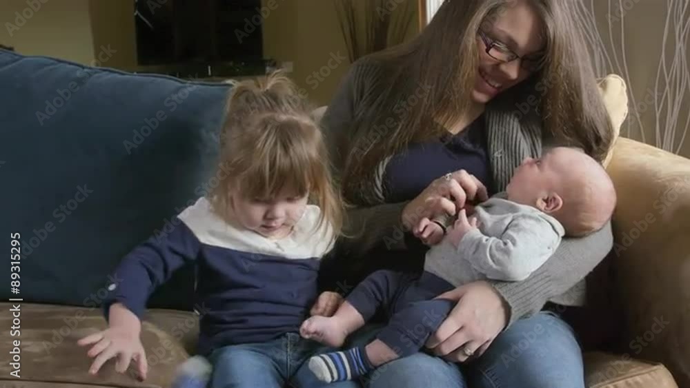 Mother with a toddler girl and newborn son Mother with a toddler girl and newborn son