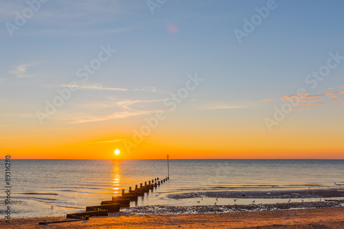 Setting sun over Hunstanton beach Groyne.