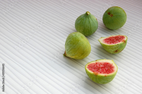 fresh fruits background with figs on white table