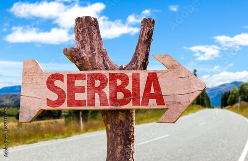 Serbia wooden sign with road background