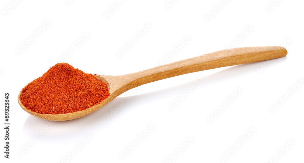 paprika on wooden spoon isolated on white paprika on wooden spoon isolated on white