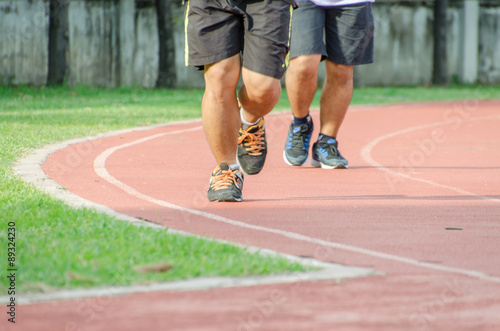 Two people running for health in trace