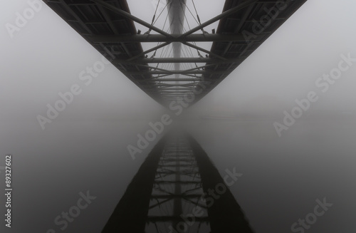 Bernatka footbridge over Vistula river in Krakow in heavy fog. #89327602