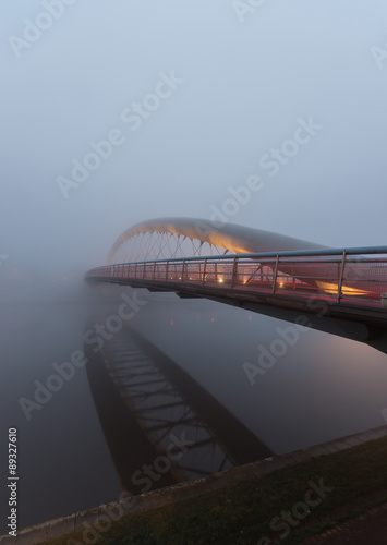 Bernatka footbridge over Vistula river in Krakow in heavy fog #89327610