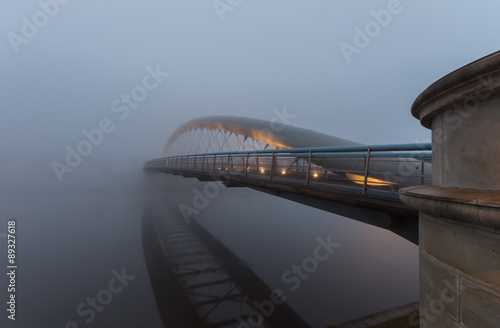 Bernatka footbridge over Vistula river in Krakow in heavy fog #89327618