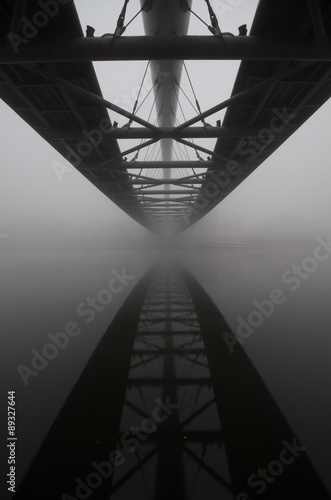 Bernatka footbridge over Vistula river in Krakow in heavy fog. #89327644
