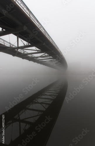 Bernatka footbridge over Vistula river in Krakow in heavy fog. #89327651