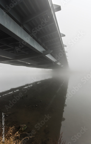 Kotlarski bridge in Krakow, Poland, during heavy fog - the longest humpbacked (arch) bridge in Poland without support in the river bottom. #89327677