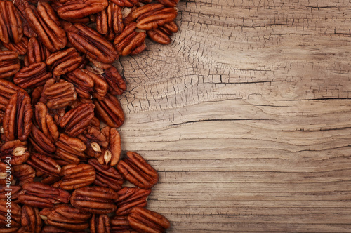 Pecan nuts on old wooden background. Top view