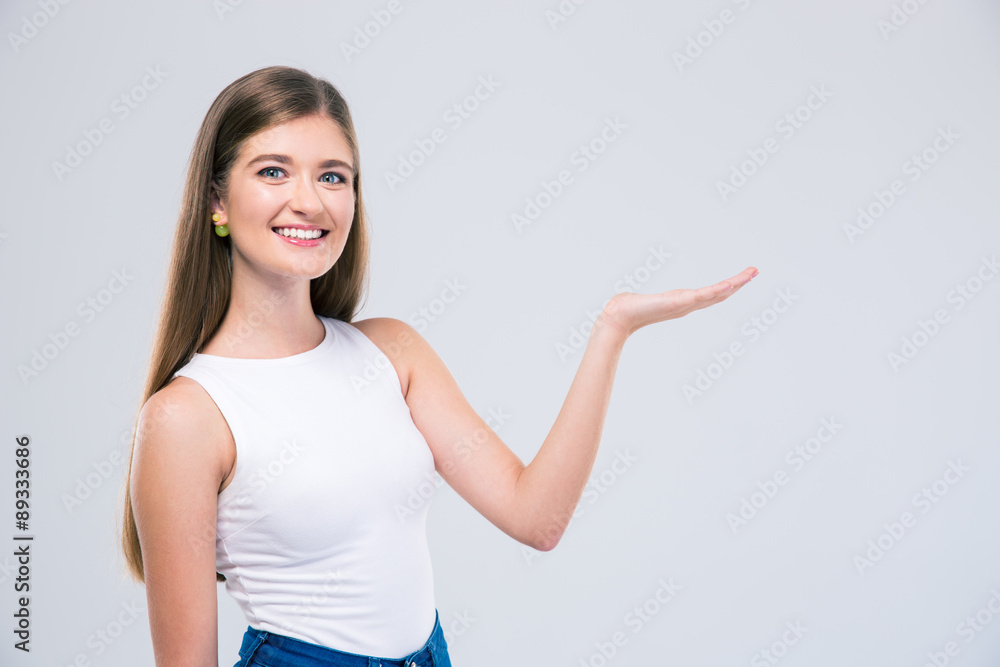 Female teenager showing copyspace on the palm Female teenager showing copyspace on the palm