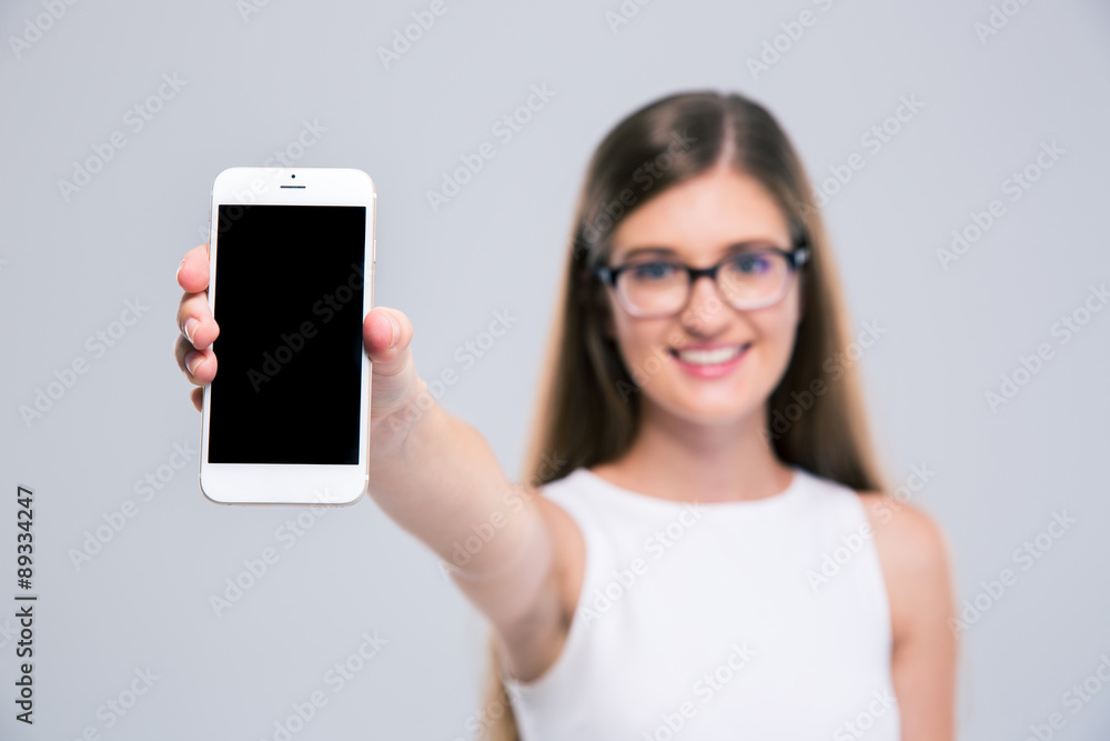 Female teenager showing blank smartphone screen Female teenager showing blank smartphone screen