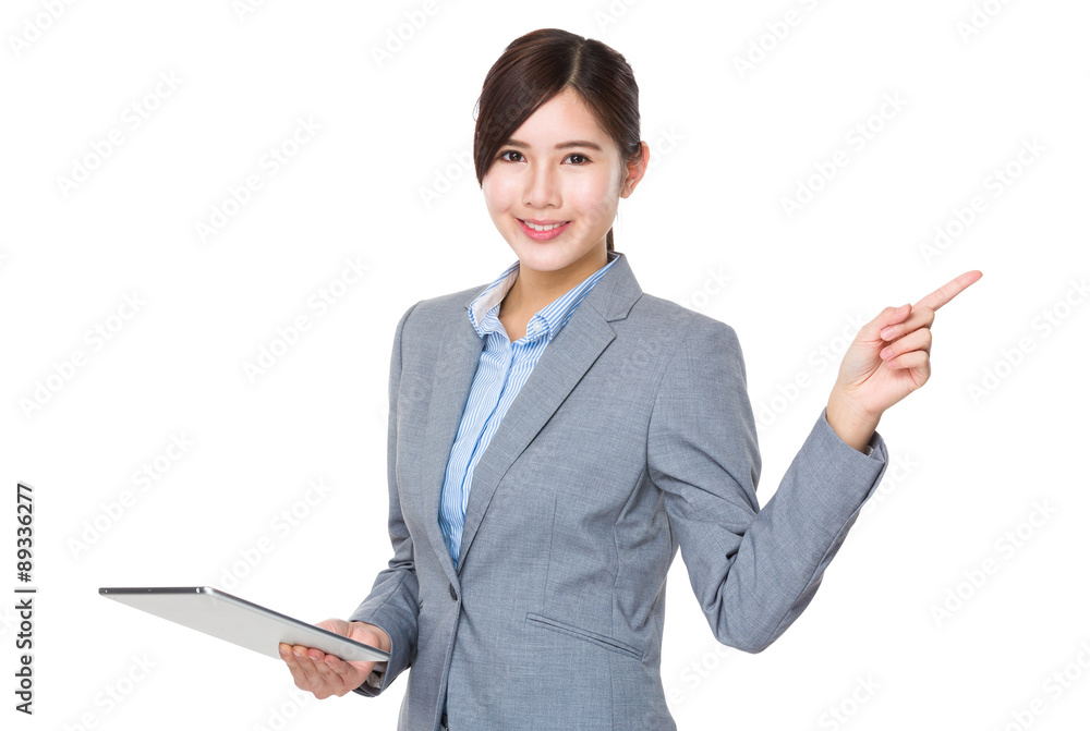 Asian Businesswoman hold with tablet pc and finger point up Asian Businesswoman hold with tablet pc and finger point up