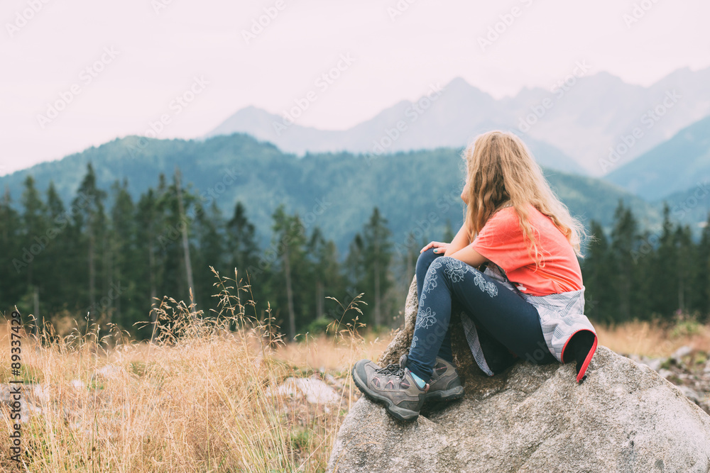 Girl is thougthful in the mountains
