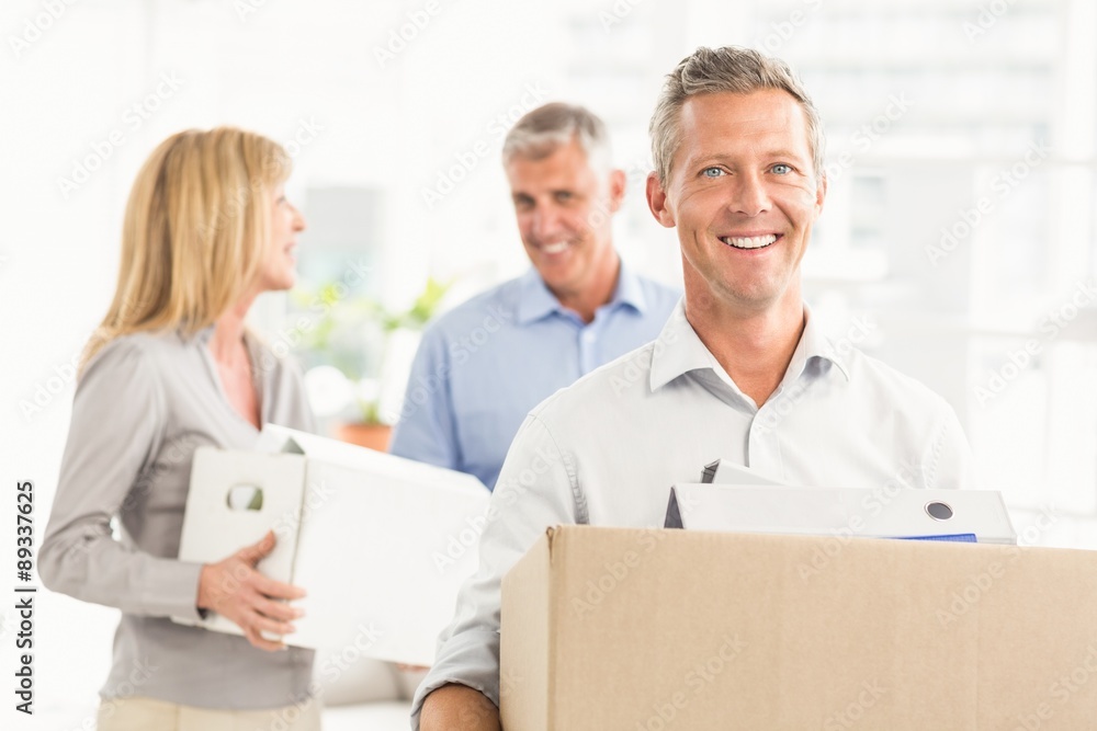 Casual business people carrying cartons Casual business people carrying cartons