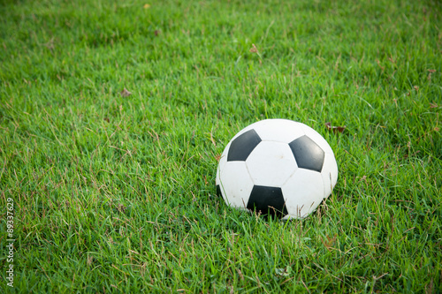 Deflated soccer ball on grass © showcake