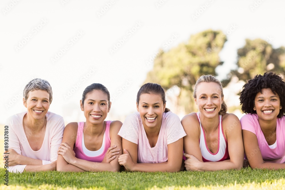 Smiling women lying in a row and wearing pink for breast cancer Smiling women lying in a row and wearing pink for breast cancer