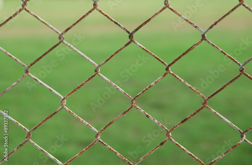 iron wire fence isolated on green background © showcake