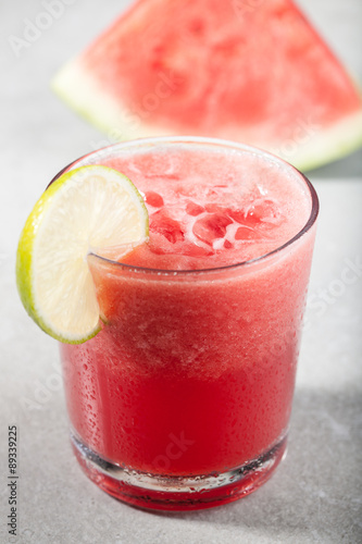 Glass of watermelon juice with ice and watermelon