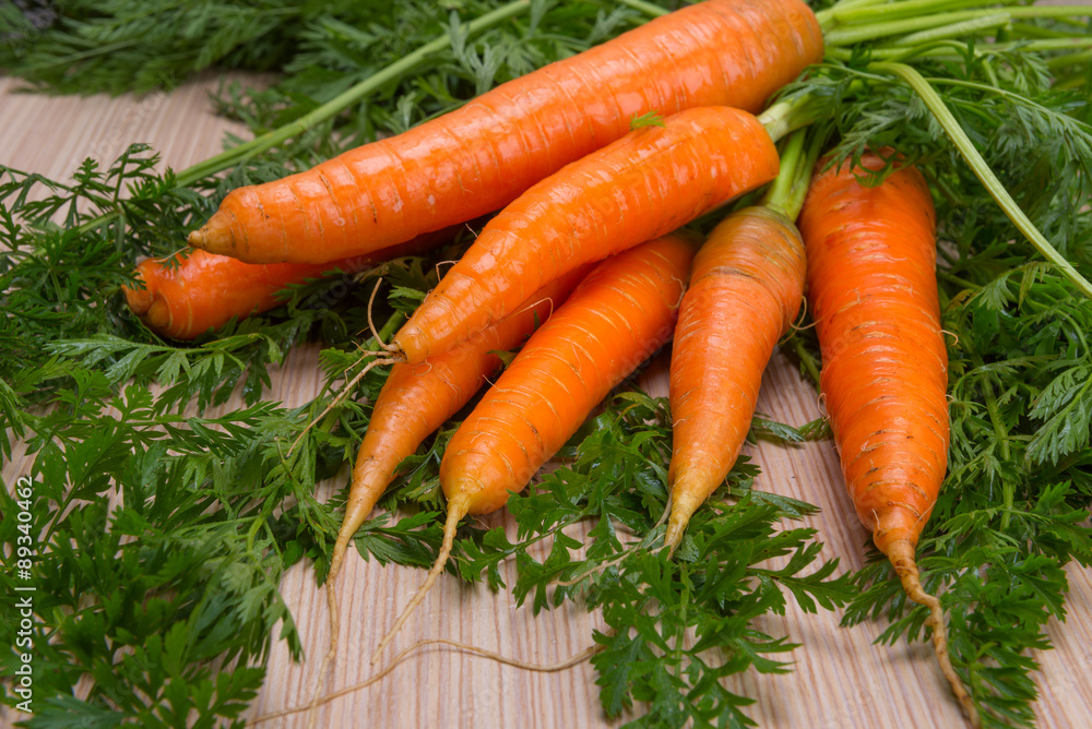 Fresh carrots with tops of vegetable Fresh carrots with tops of vegetable