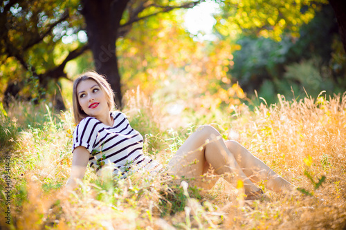 woman sitting on yellow grass