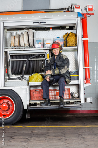 Happy Fireman Holding Coffee Mug In Truck