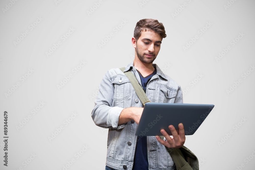 Composite image of student using tablet in library Composite image of student using tablet in library
