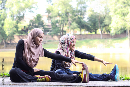 two young muslim women is stretching