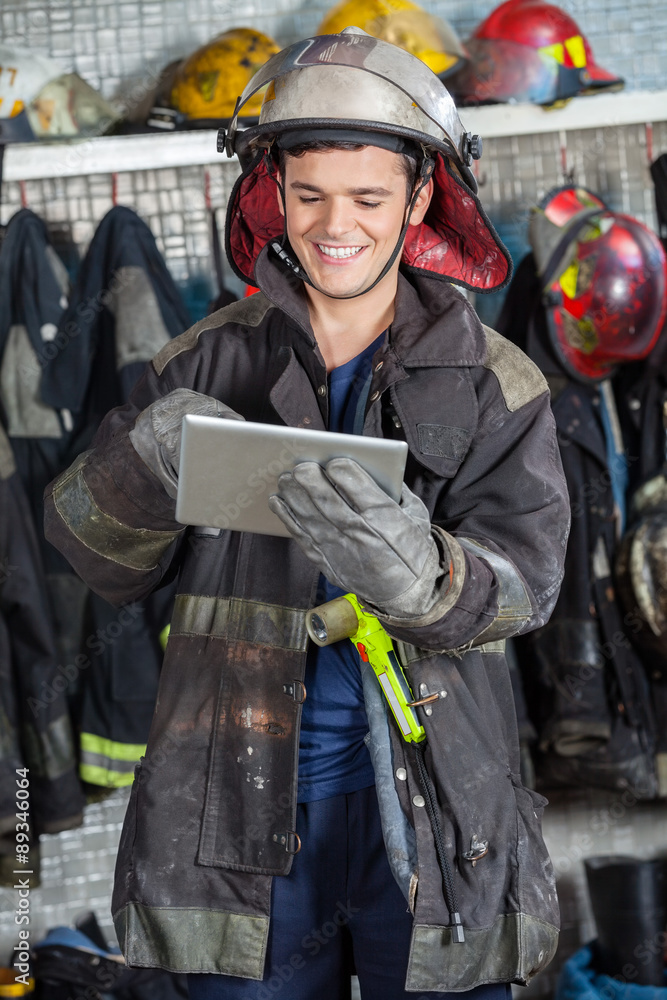 Happy Fireman Using Digital Tablet Happy Fireman Using Digital Tablet