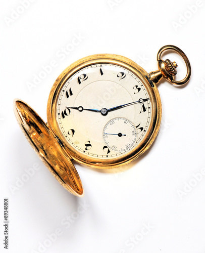 Old golden pocket watch on white background