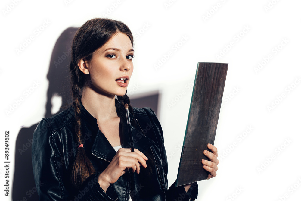 woman looking in the mirror and applying cosmetic woman looking in the mirror and applying cosmetic
