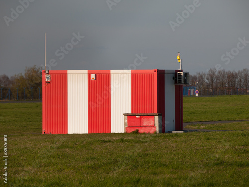 Small red-white booth on the airport photo